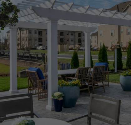 a patio with tables and chairs under a white canopy at Siena Luxury Residences Apartments, Cinnaminson, 08077