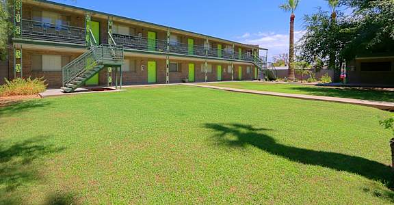 a large green lawn in front of a building