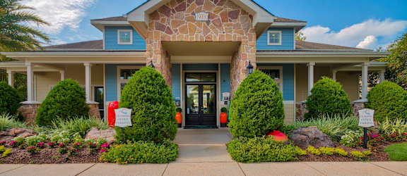A Building With Stone Pillar Entrance at Villas at Bon Secour Apartments, Gulf Shores
