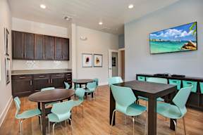 A modern dining room with a wooden table and chairs.