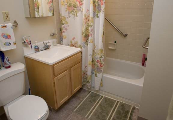 a bathroom with a toilet sink and tub and a shower curtain