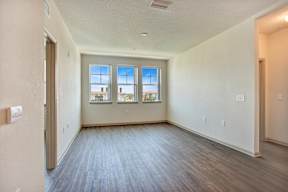 A room with a window overlooking a building.