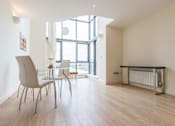 Thumbnail 1 of 3 - a dining room with a table and chairs and a large window
