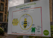 Thumbnail 6 of 6 - a sign with a bee and a child drawn on it