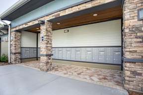 A garage door is closed and there are 11 lockers on the wall.
