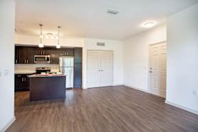 A kitchen with dark wood cabinets and a white fridge.