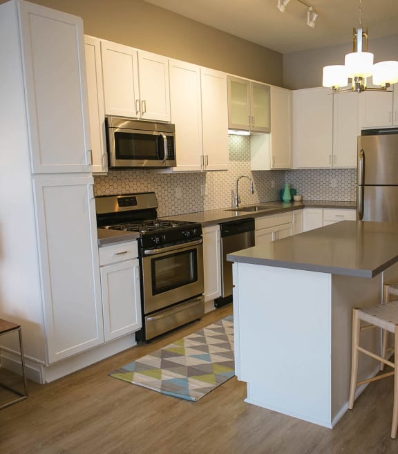 a kitchen and dining area with a wooden table and chairs