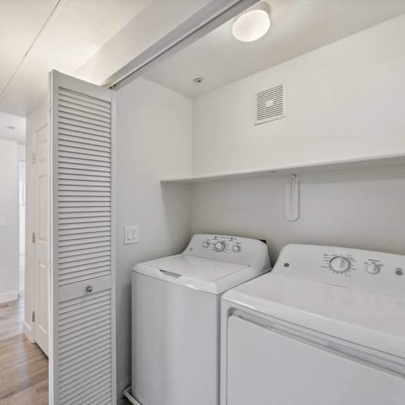A white washer and dryer in a laundry room.
