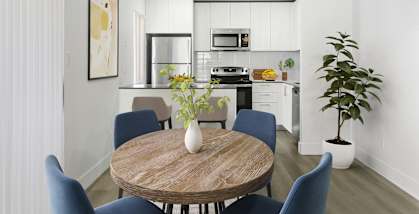 a kitchen and dining room with a table and chairs