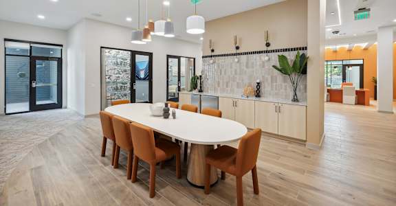 a dining room with a white table and chairs