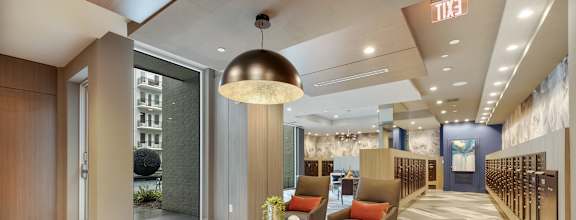a lobby with couches and chairs and a table