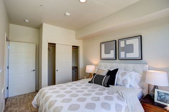Bedroom with cozy bed at Commons at Sylvan Canyon Apartments, Portland, Oregon