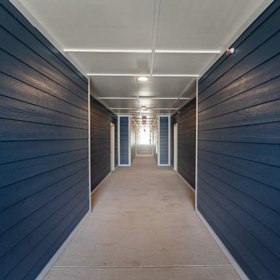 A long, narrow hallway with a light at the end.