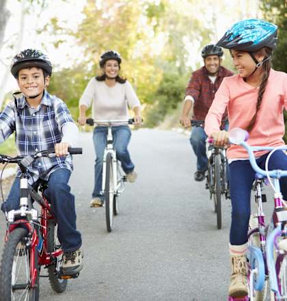 A group of people riding bikes on a road at Union at Rivers Edge, Des Moines, IA