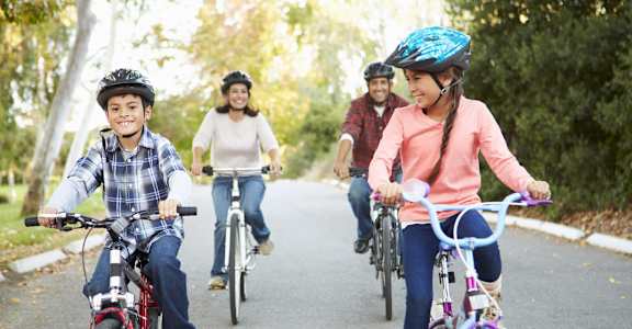 a group of people riding bikes on a road