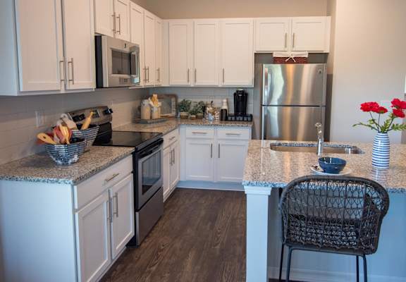 a kitchen with granite counter tops and stainless steel appliances