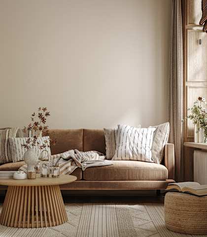 a living room with a brown couch and a coffee table