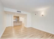 Thumbnail 3 of 14 - the living room and kitchen of an apartment with wood flooring  at Palm Gardens @ Biscayne Gardens, North Miami, FL