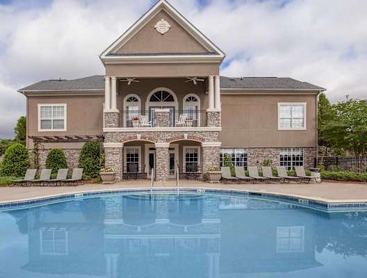 A large house with a pool in front.at Carrington Place at Wildewood, South Carolina