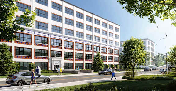 A modern building with a red and white facade and people walking in front.