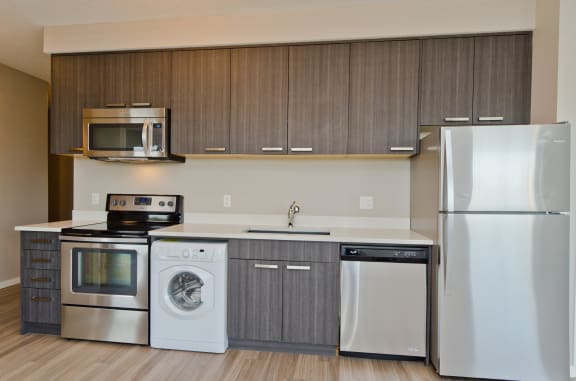 a kitchen with stainless steel appliances and a white refrigerator