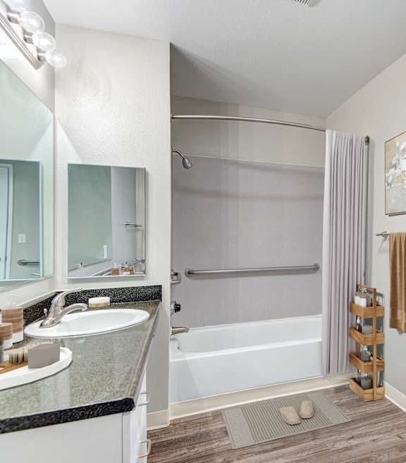 A bathroom with a white sink and a white tub.