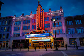 A brightly lit marquee on a building at night.