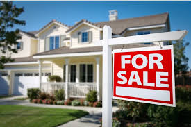 a for sale sign in front of a house