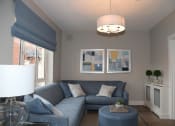 Thumbnail 2 of 3 - a living room with a blue couch and a table