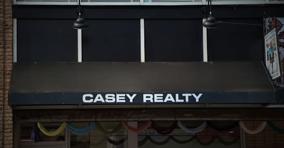 A Casey Realty sign is displayed on a building.