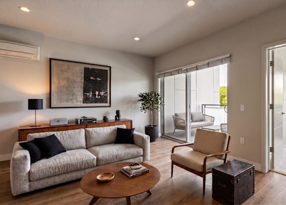 A living room with a couch, chair, and coffee table.