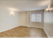 Thumbnail 4 of 14 - an empty living room with wood floors and a window  at Palm Gardens @ Biscayne Gardens, North Miami, FL