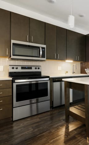 a kitchen with stainless steel appliances and a white counter top