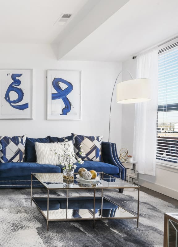 three paintings hanging on a wall in a room with wood floors
