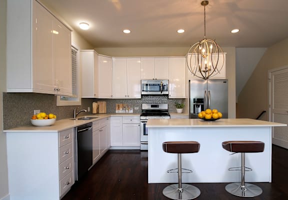 a kitchen with white cabinets and a counter top
