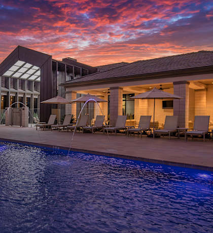 A large house with a pool in the foreground.