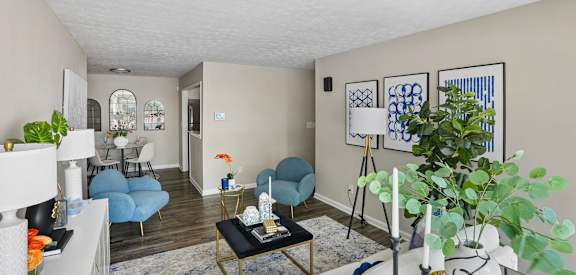 A living room with a blue chair and a black coffee table.