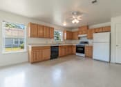 Thumbnail 8 of 8 - an empty kitchen with wooden cabinets and a white refrigerator at Huntington Village **, Georgia