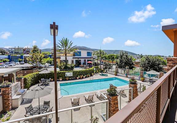 a view of the pool from a balcony at the resort