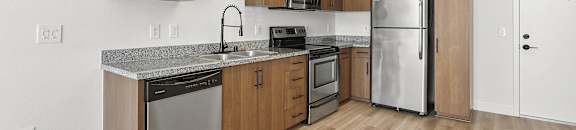a kitchen with wooden cabinets and stainless steel appliances