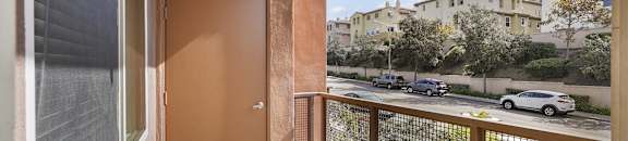 a view of the street from a balcony with a door
