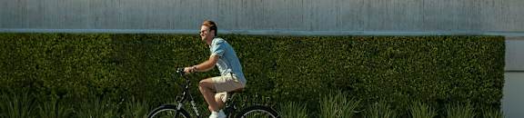 a man riding a bike down the street