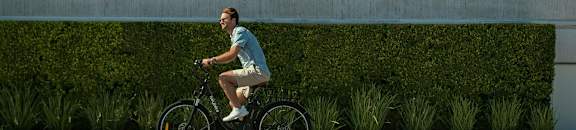A man riding a bike on a road.
