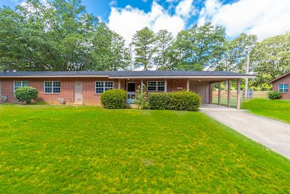 the front of a brick house with a lawn and a driveway at Huntington Village **, Warner Robins, 31098