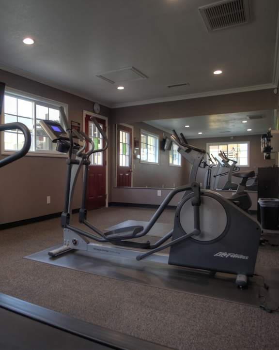 Gym with cardio equipment at Raintree Apartments, Highland, CA 92346