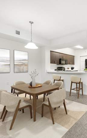 A modern dining room with a wooden table and chairs.
