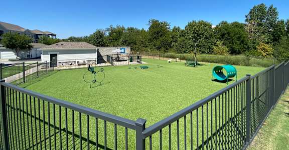 a fenced turf pet park at Steele Crossing, Arkansas, 72703