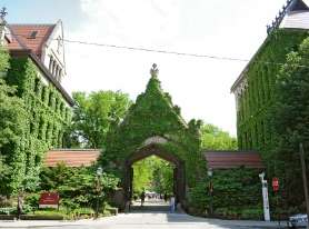 a building with an archway covered in green ivy