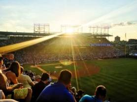 a crowd of people sitting on top of a baseball field