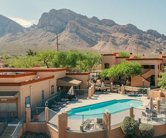 A resort with a pool and a mountain in the background.